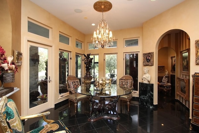 dining space featuring a healthy amount of sunlight and an inviting chandelier