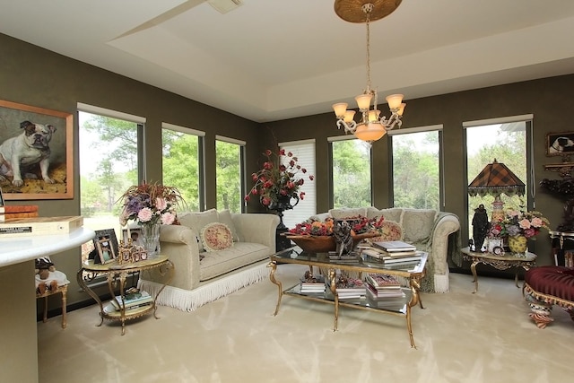 interior space featuring a tray ceiling and an inviting chandelier