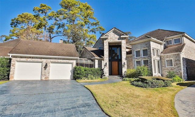 view of front facade with a garage and a front lawn