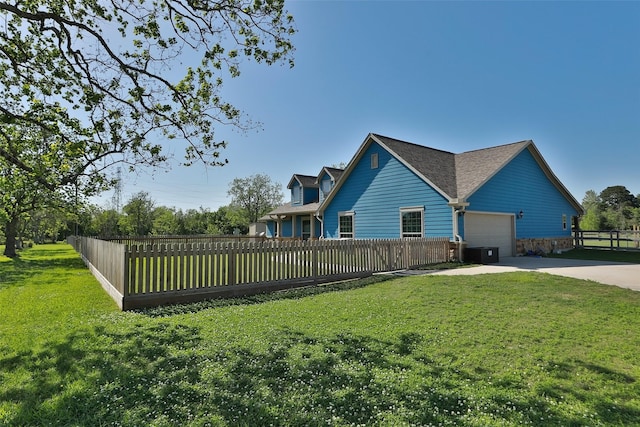 view of property exterior with a lawn, a garage, and central AC unit