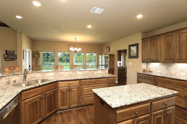 kitchen with a chandelier, stainless steel dishwasher, decorative light fixtures, tasteful backsplash, and dark hardwood / wood-style flooring