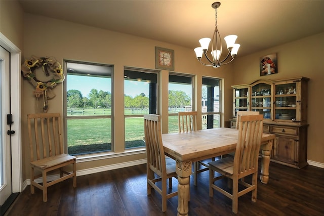 dining area featuring an inviting chandelier and dark wood-type flooring