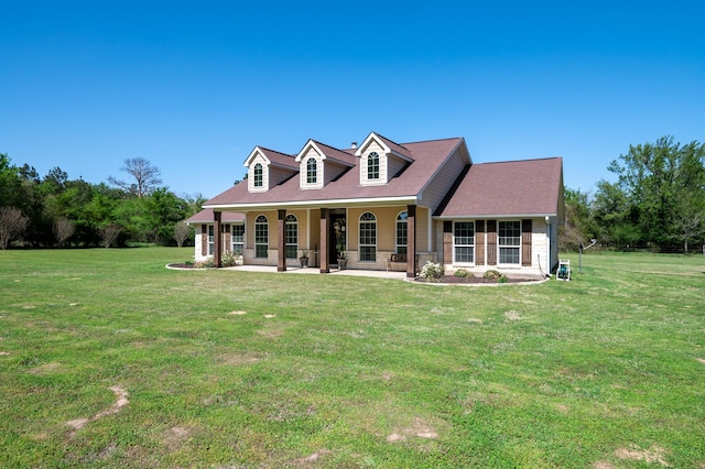 back of property featuring covered porch and a yard