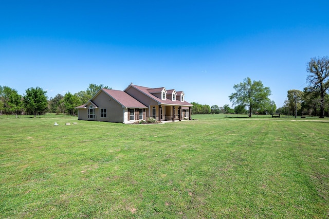 rear view of property with a yard