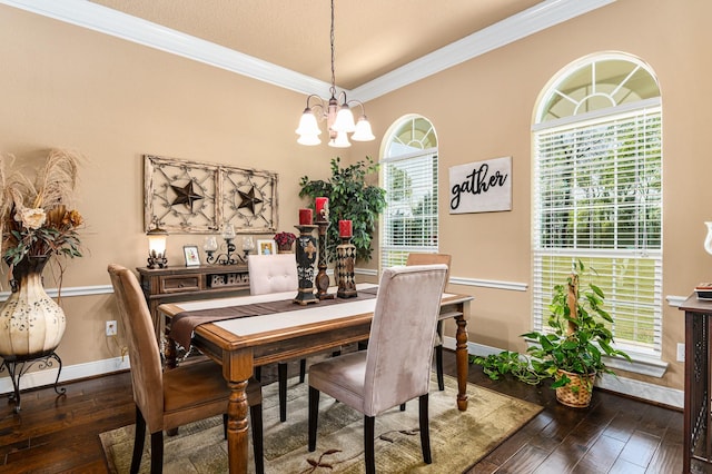 dining room featuring crown molding, dark wood-type flooring, and an inviting chandelier