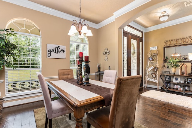 dining room with an inviting chandelier, crown molding, dark hardwood / wood-style floors, and a textured ceiling