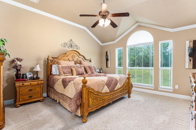 carpeted bedroom featuring vaulted ceiling, ornamental molding, a textured ceiling, and ceiling fan