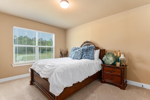 carpeted bedroom featuring a textured ceiling