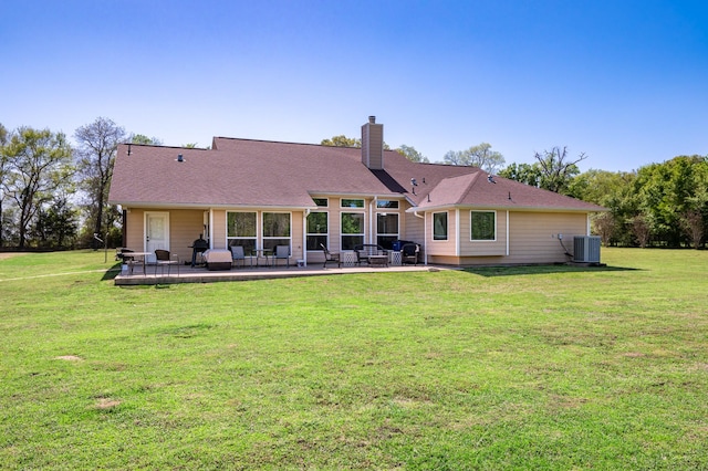 rear view of property featuring central AC, a lawn, and a patio