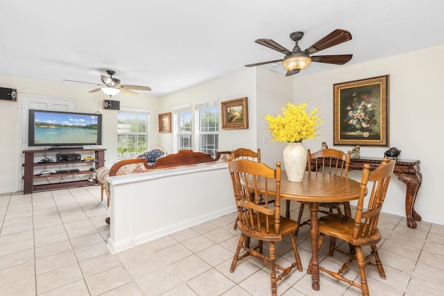 tiled dining space with ceiling fan