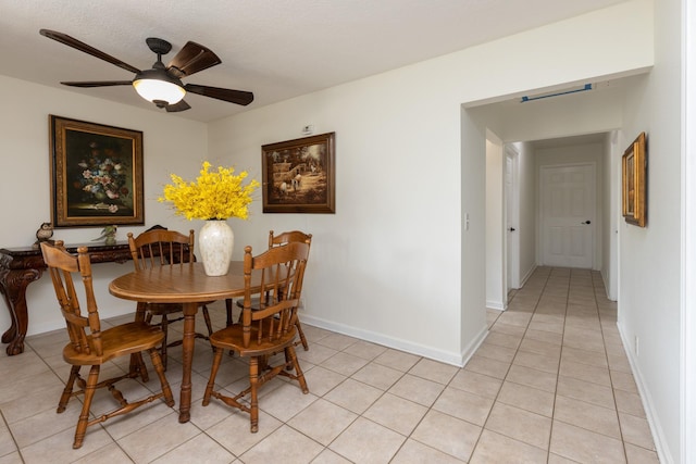 dining space featuring ceiling fan and light tile flooring