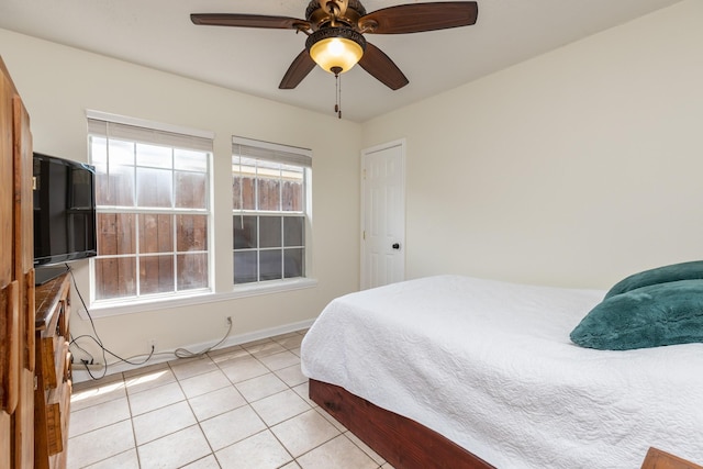 tiled bedroom with ceiling fan