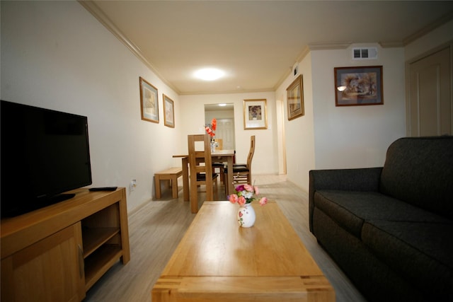 living room with crown molding and light wood-type flooring