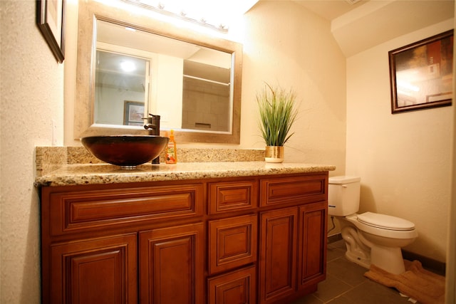 bathroom with vanity, tile flooring, and toilet