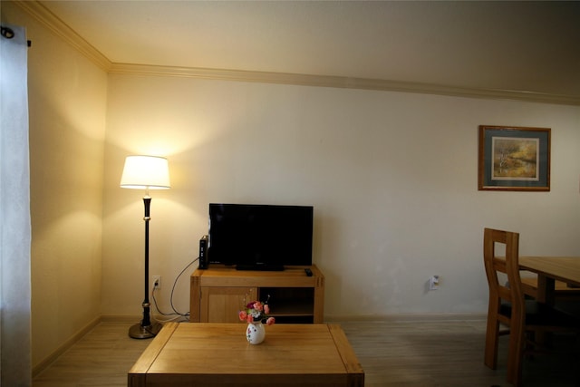 living room featuring hardwood / wood-style floors and crown molding