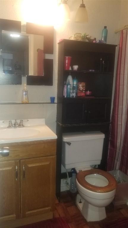 bathroom featuring toilet and vanity