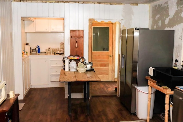 kitchen with dark hardwood / wood-style floors and stainless steel fridge