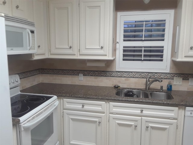 kitchen featuring white appliances, white cabinetry, and tasteful backsplash