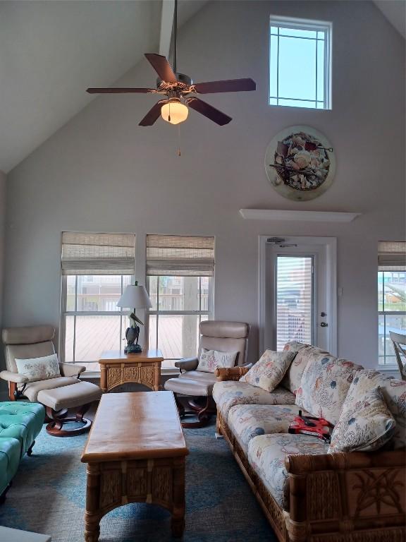 living room with ceiling fan, high vaulted ceiling, and a wealth of natural light