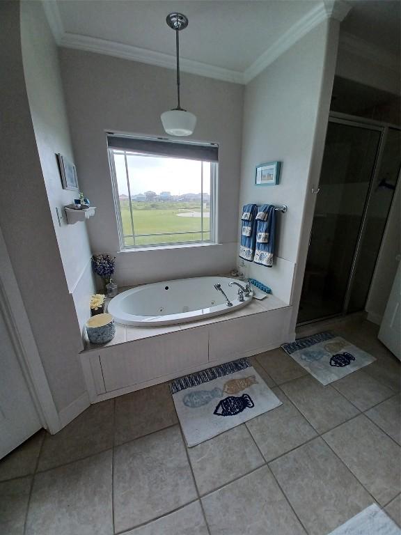 bathroom with crown molding, tile floors, and plus walk in shower