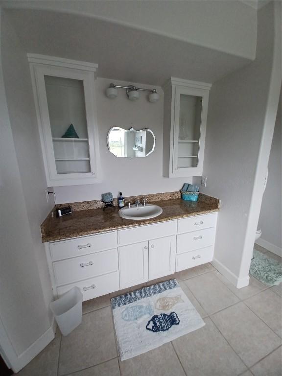 bathroom featuring tile flooring and vanity