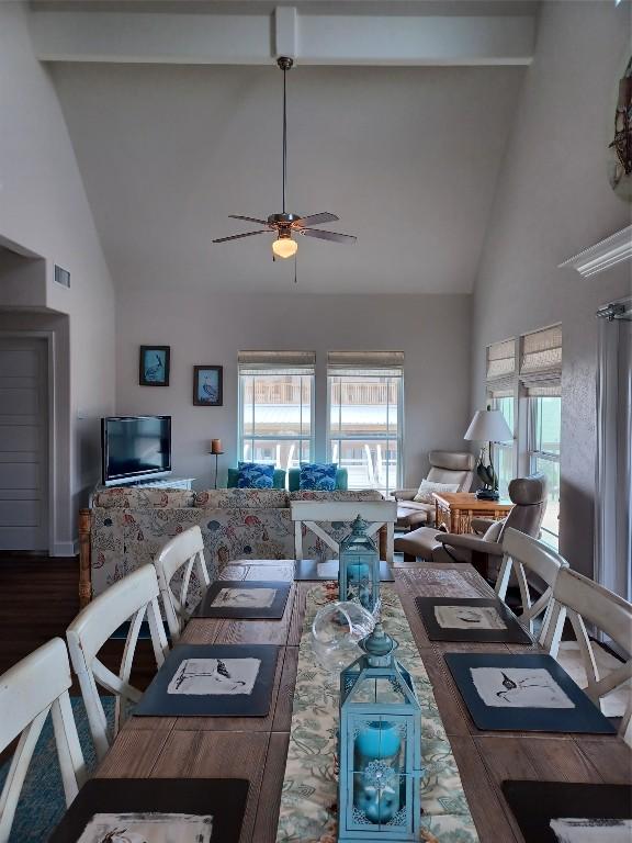 living room with high vaulted ceiling, wood-type flooring, ceiling fan, and beamed ceiling