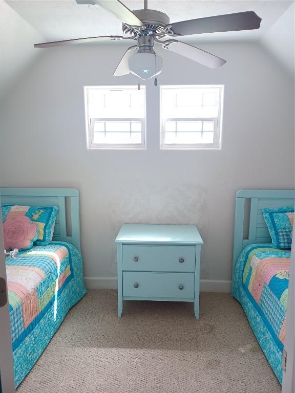 bedroom featuring light carpet, lofted ceiling, and ceiling fan