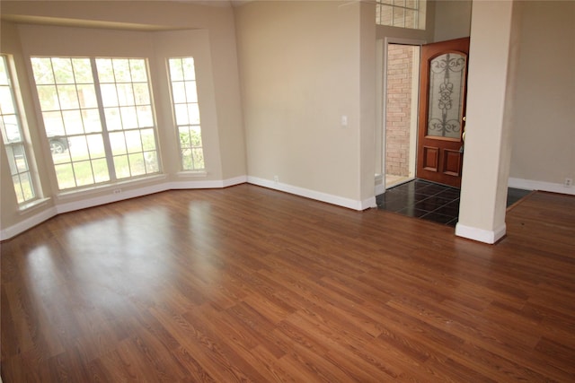 unfurnished room featuring dark tile floors