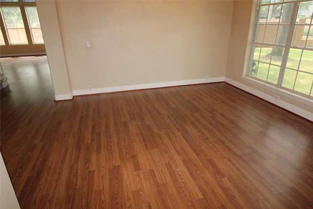 spare room featuring dark hardwood / wood-style floors