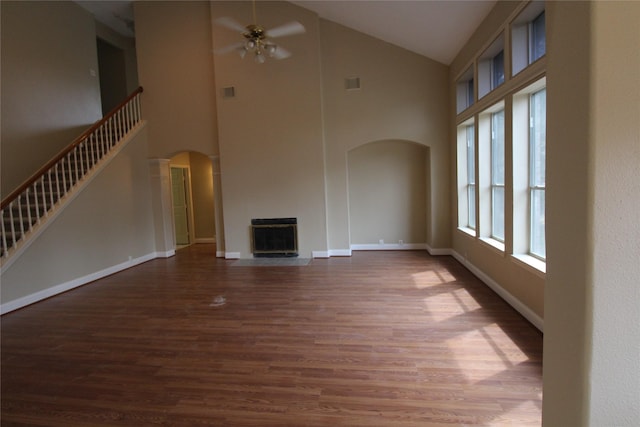 unfurnished living room with ceiling fan, high vaulted ceiling, and dark hardwood / wood-style flooring