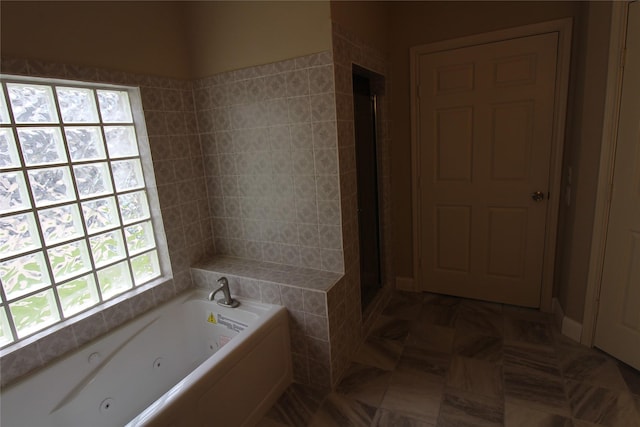 bathroom with tile flooring and independent shower and bath