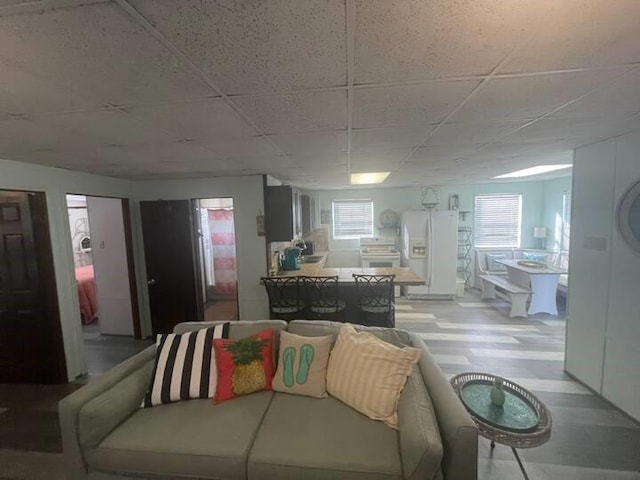 living room with a paneled ceiling