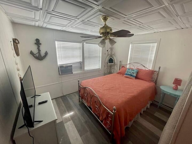 bedroom with coffered ceiling, dark hardwood / wood-style floors, and ceiling fan