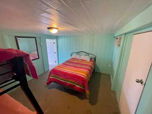 bedroom featuring concrete flooring