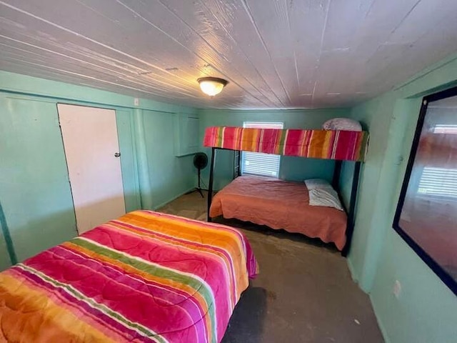 bedroom featuring concrete floors