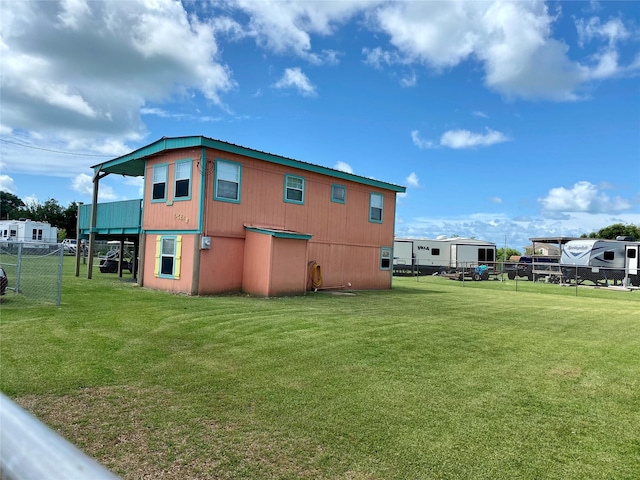 rear view of property with a yard