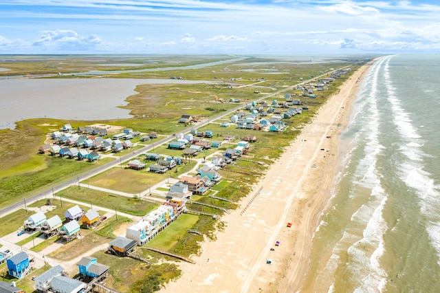 drone / aerial view featuring a beach view and a water view