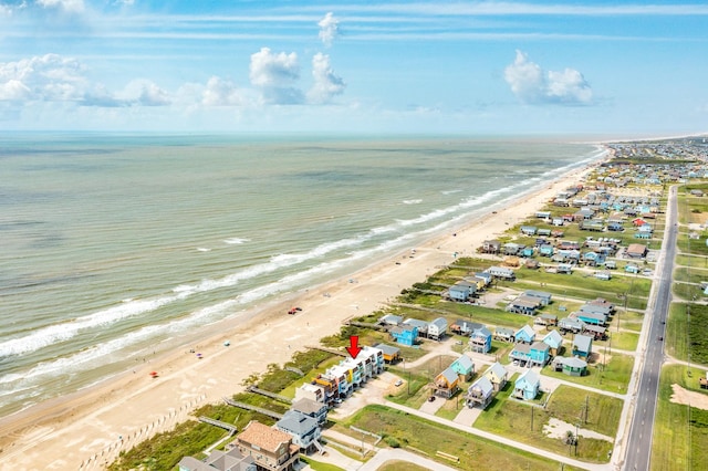 birds eye view of property with a beach view and a water view