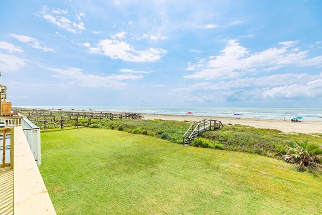 view of yard featuring a water view and a view of the beach