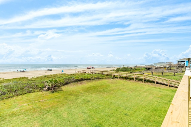 view of yard with a water view and a view of the beach