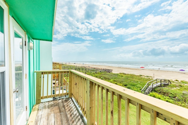 balcony with a water view and a beach view