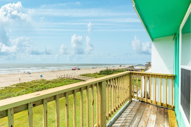 balcony featuring a beach view and a water view