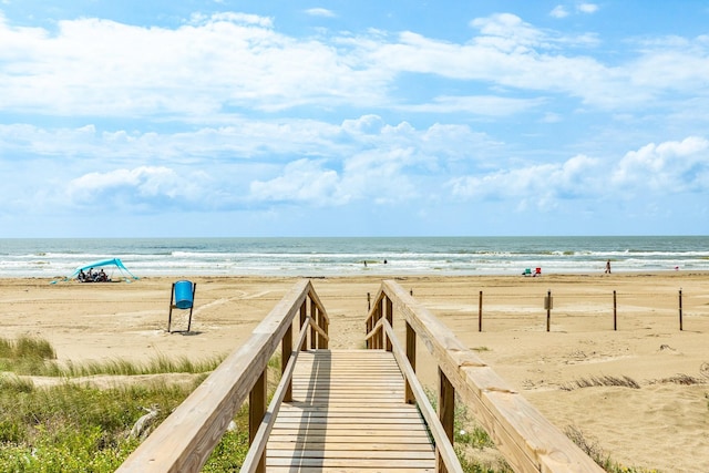 surrounding community featuring a water view and a view of the beach