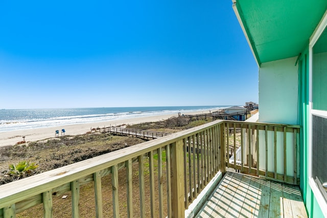 balcony with a water view and a beach view