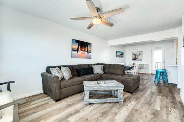 living room with light hardwood / wood-style flooring and ceiling fan