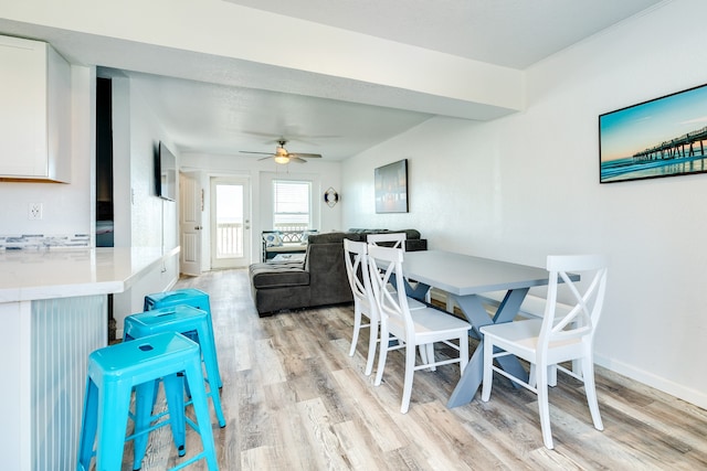 dining area featuring light hardwood / wood-style flooring and ceiling fan