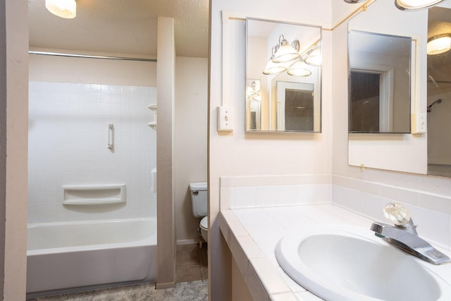 full bathroom featuring tiled shower / bath, toilet, tile floors, and vanity