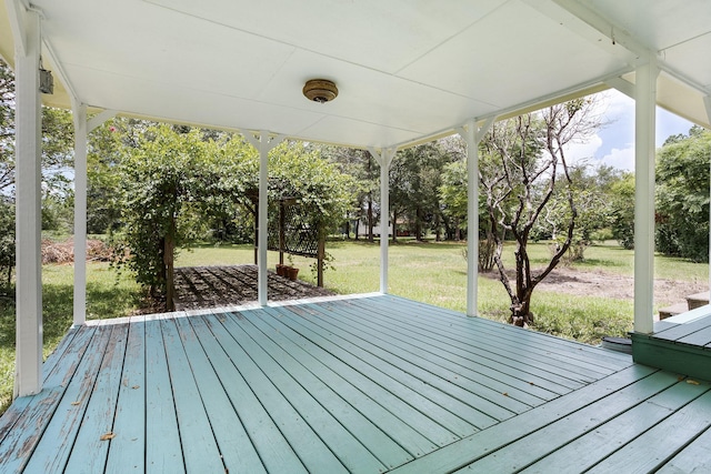 wooden deck featuring a lawn