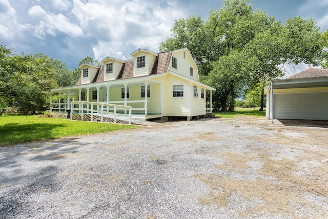 view of front of house featuring a porch and a garage