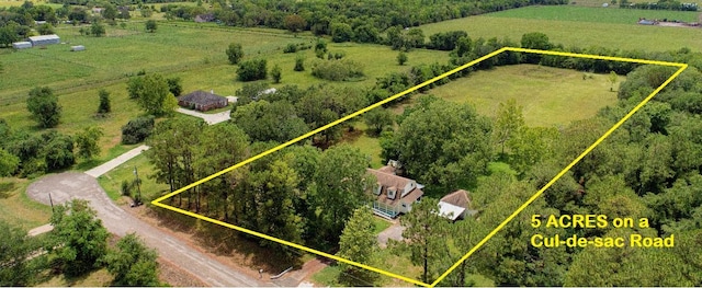 birds eye view of property with a rural view